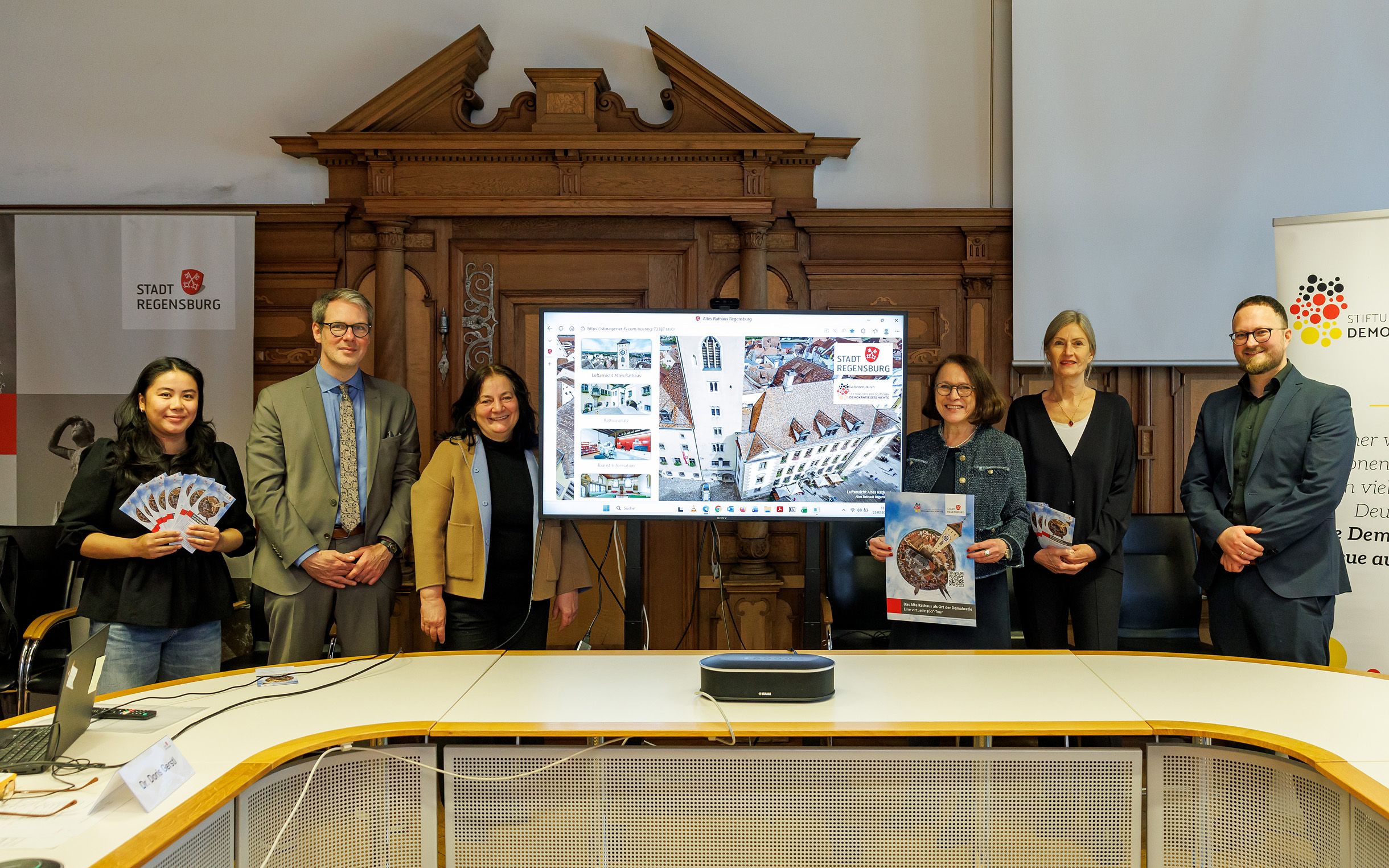 Fotografie – (v. l. n. r.) Thanh-Thanh Bui (Stadt Regensburg, Amt für Information und Kommunikation), Dr. Sebastian Karnatz (Leiter der Museen der Stadt Regensburg), Dr. Doris Gerstl (Museen der Stadt Regensburg), Oberbürgermeisterin Gertrud Maltz-Schwarzfischer, Prof. Dr. Harriet Rudolph (Universität Regensburg, Lehrstuhl für Neuere Geschichte), David Barth (Stiftung Orte der Deutschen Demokratiegeschichte)