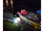 Einsatzkräfte retten die Person auf ein Boot