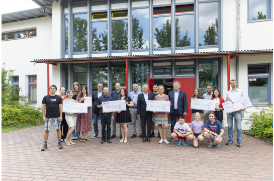 Fotografie: Bürgermeister Ludwig Artinger (Mitte) und der Leiter des Amtes für Schulen Stephan Weinmann (6. v. l.) verliehen die diesjährigen Öko-Schulpreise. 