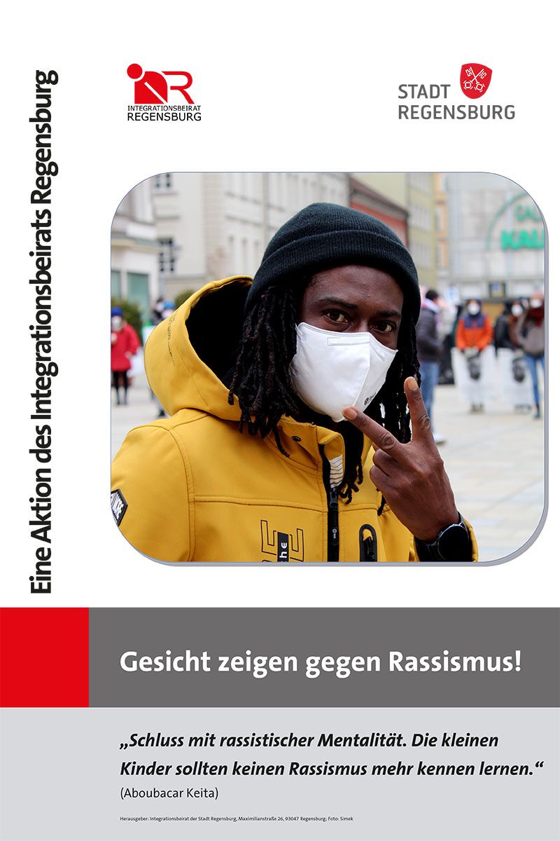 •	Portraitfoto von Herr Aboubacar Keita zur Aktion Gesicht zeigen gegen Rassismus. Darunter sein Zitat: „Schluss mit rassistischer Mentalität. Die kleinen Kinder sollten keinen Rassismus mehr kennen lernen.“