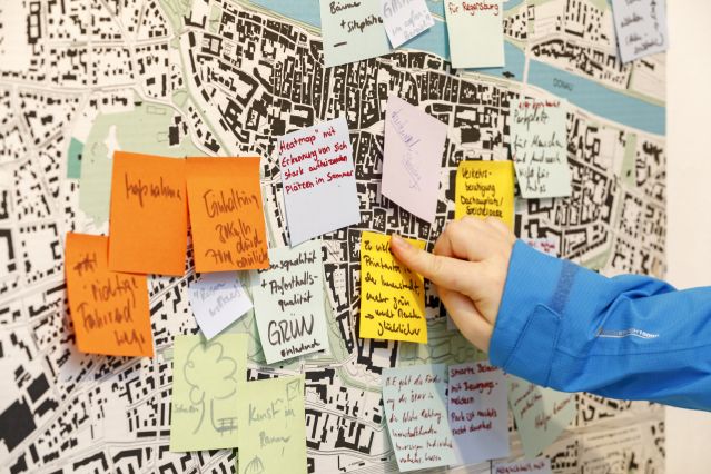 Post-its werden auf Stadtplan geklebt