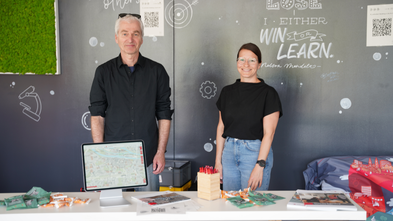 Frau Maier und Herr Daiber betreuen den R_NEXT Stand beim diesjährigen Hackathon.