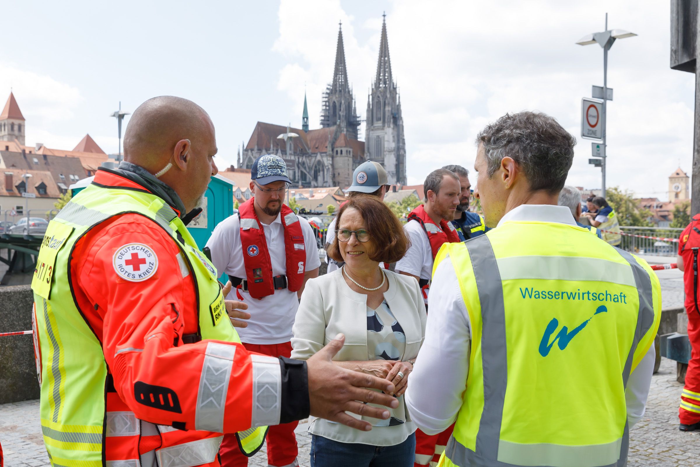 Fotografie: Oberbürgermeisterin Gertrud Maltz-Schwarzfischer im Gespräch mit einem Vertreter des Deutschen Roten Kreuzes und einem Vertreter des Wasserwirtschaftsamtes
