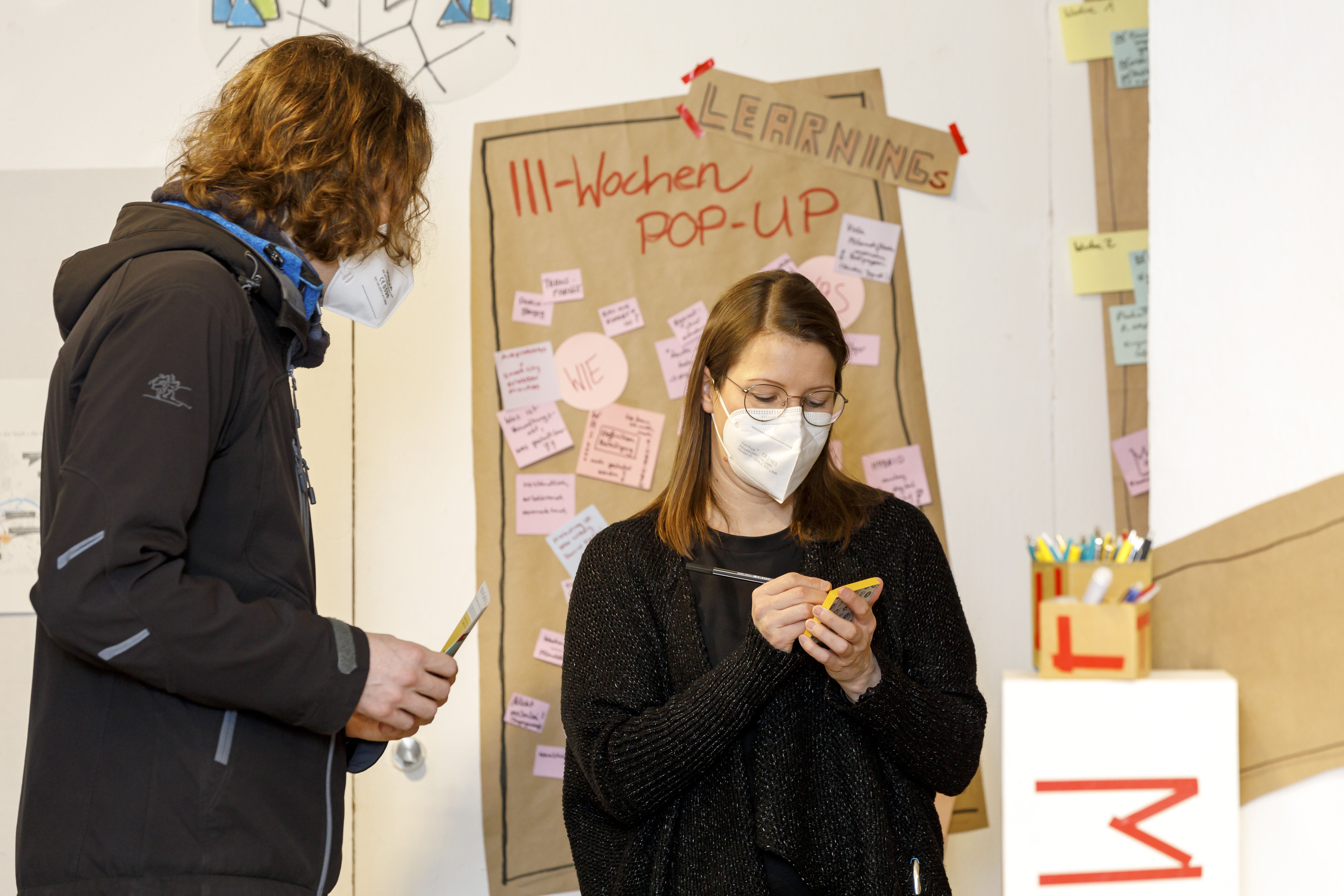 Franziska Meier notiert eine Idee im Gespräch mit einer Besucherin.