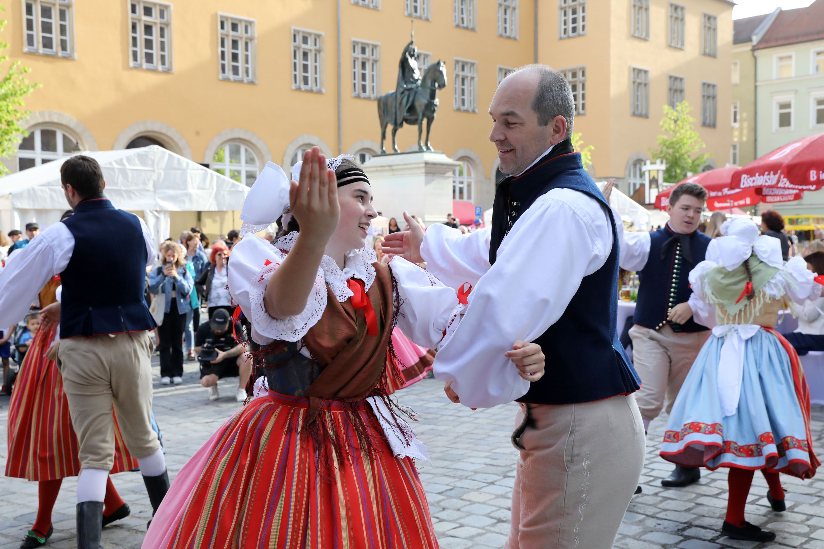 Fotografie: Paare in Tracht bei einem von einer Partnerstadt aufgeführten Volkstanz