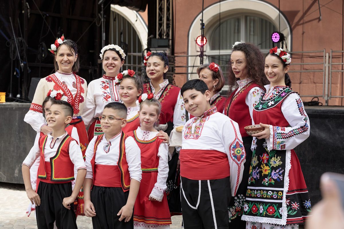 Gruppenbild einer bulgarischen Tanzgruppe in traditioneller rot, weißer Tracht