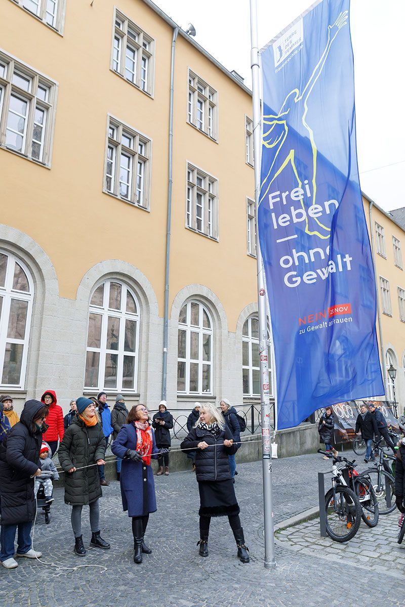 Fotografie - Oberbürgermeisterin Gertrud-Maltz Schwarzfischer hisst gemeinsam mit Maria Scharfenberg (stv. Landrätin), Simone Seitz (Frauennotruf Regensburg e.V.) und Regina Hellwig-Schmid (Städtegruppe Terre des Femmes Regensburg) die Fahne gegen Gewalt an Frauen