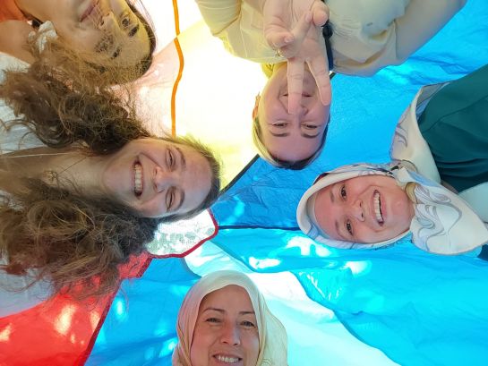 Fotografie: Eltern-Kind Gruppe mit Eva Döllinger unter dem Schwungtuch  (C) Zilya Bilalutdinow