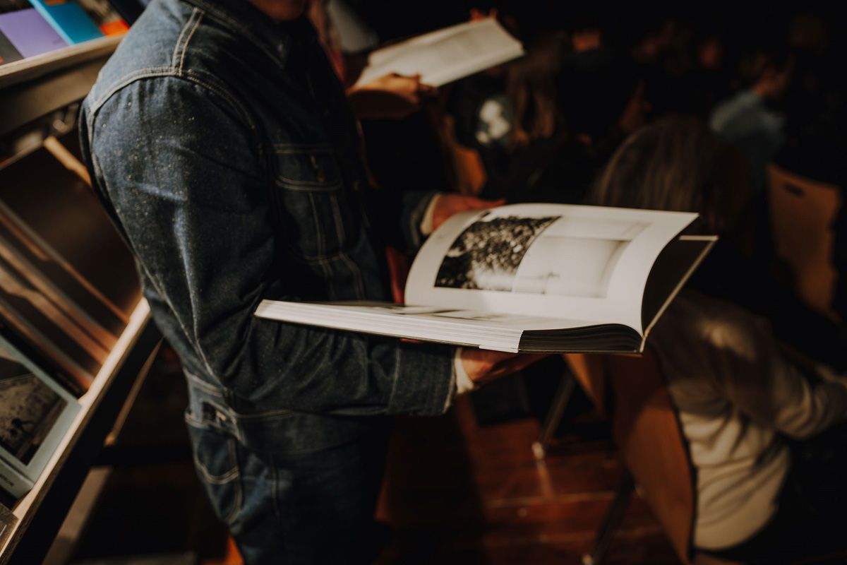 Fotografie – Person mit offenem Buch in der Hand