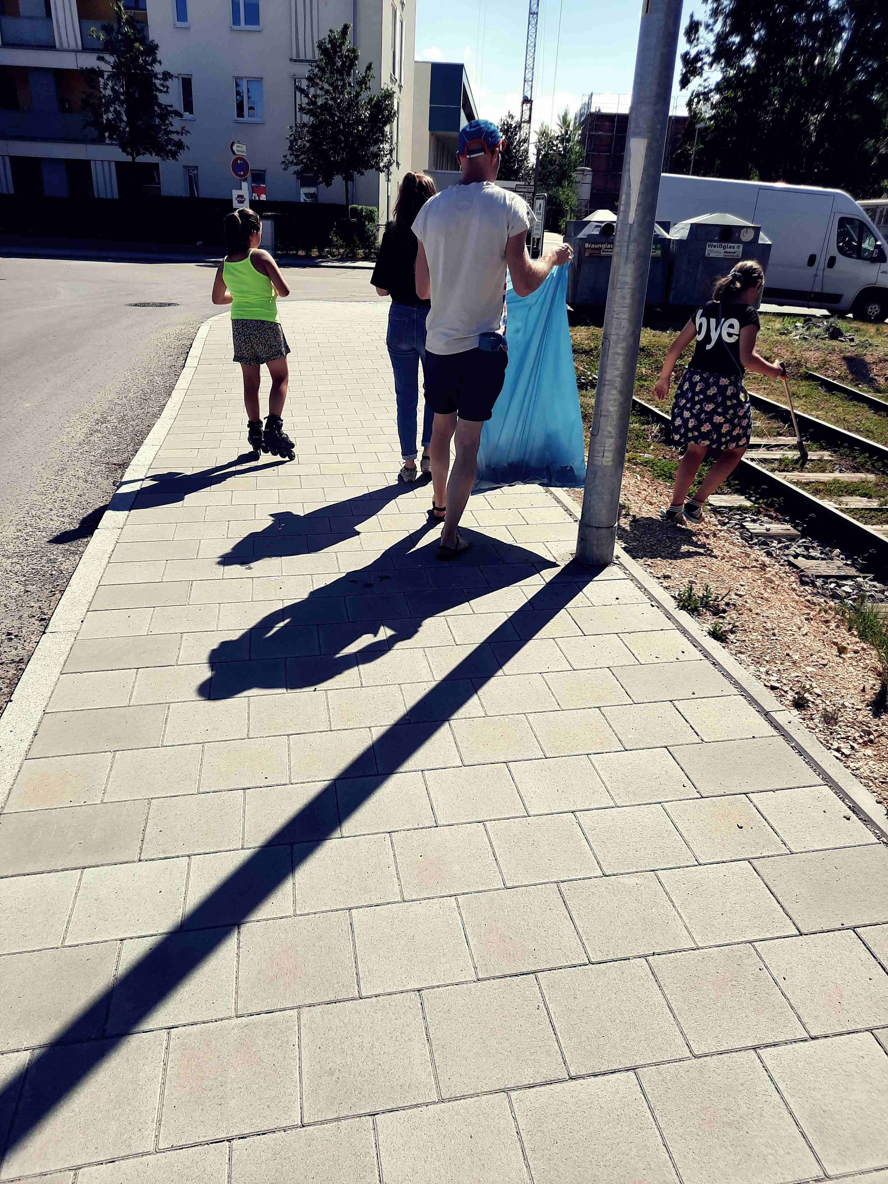 Auf dem Foto sind mehrere Personen zu sehen die Müll sammeln.