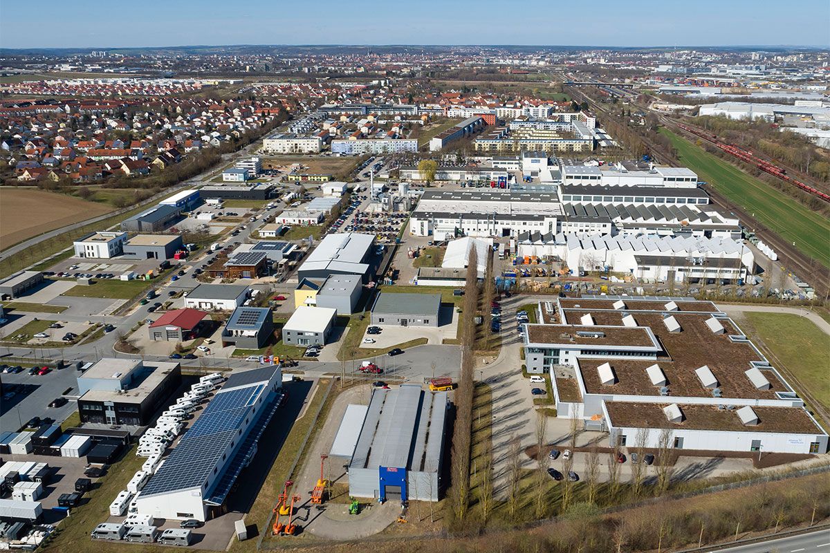 Fotografie - Luftbild Gewerbegebiet Burgweinting Süd, links im Bild Wohnbebauung, im Hintergrund Stadtgebiet Regensburg
